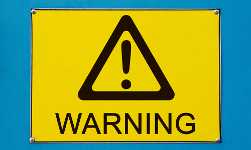 yellow warning sign on blue background